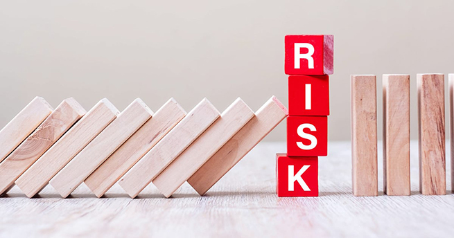 Red RISK cube blocks stop falling blocks on table. fall Business, planning, Management, Solution, Insurance and strategy Concepts